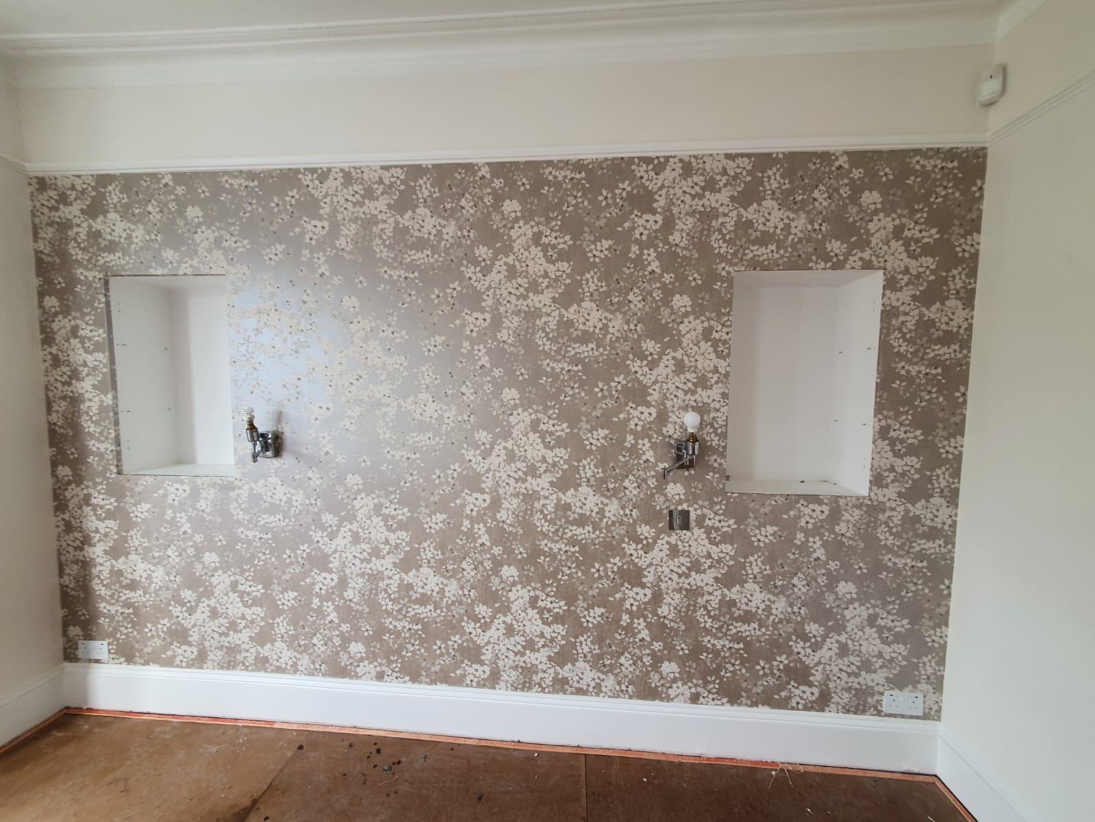Metallic blossom branch wallpaper on chimney breast, Essex